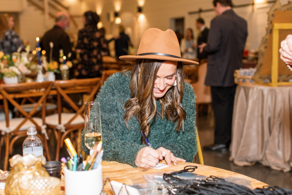 Wedding calligrapher Bethany Riegel of Joy Unscripted on-site during an event at Chestnut Ridge